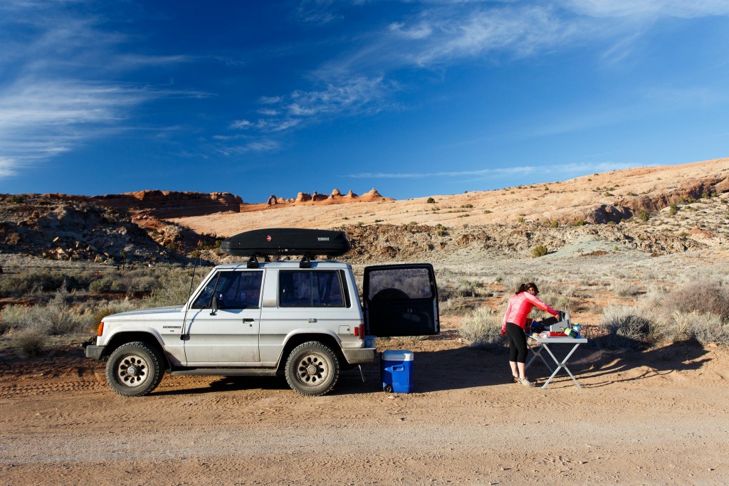 Ariel cooking Dinner. Delicate Arch in the back